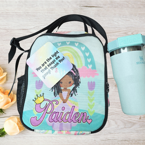 Personalized lunch bag with a girl design and a water bottle on a wooden surface with flowers.
