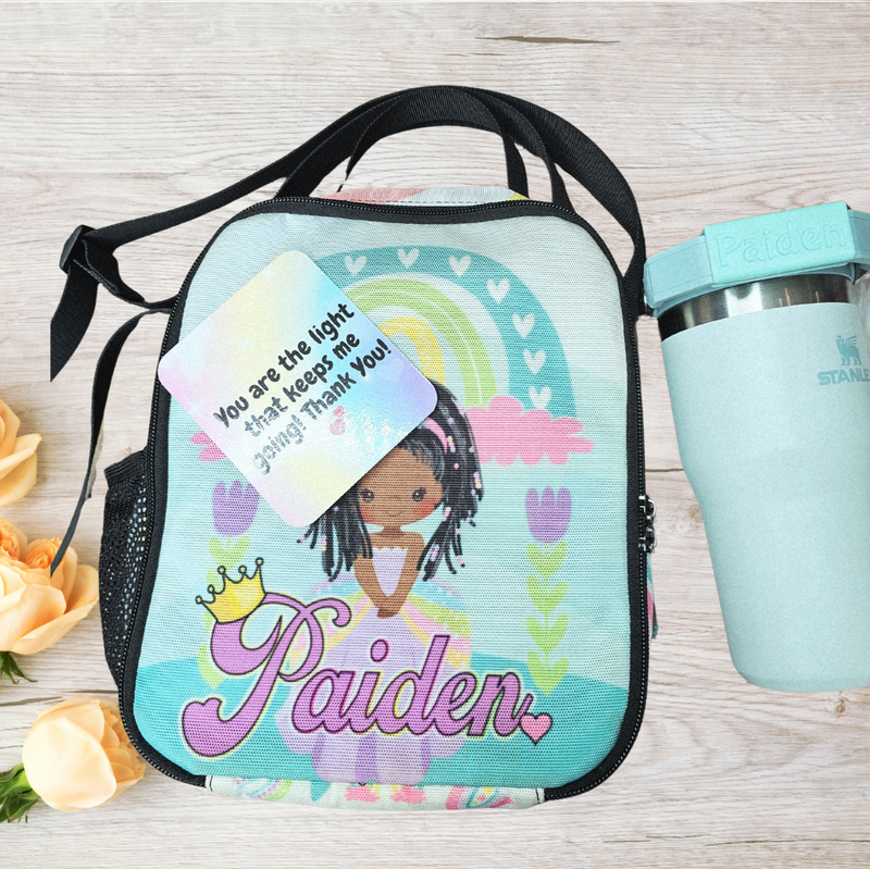 Personalized lunch bag with a girl design and a water bottle on a wooden surface with flowers.